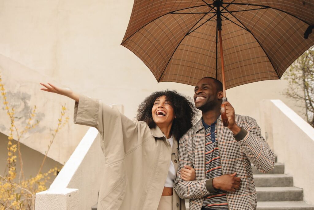 Happy Couple Holding Umbrella