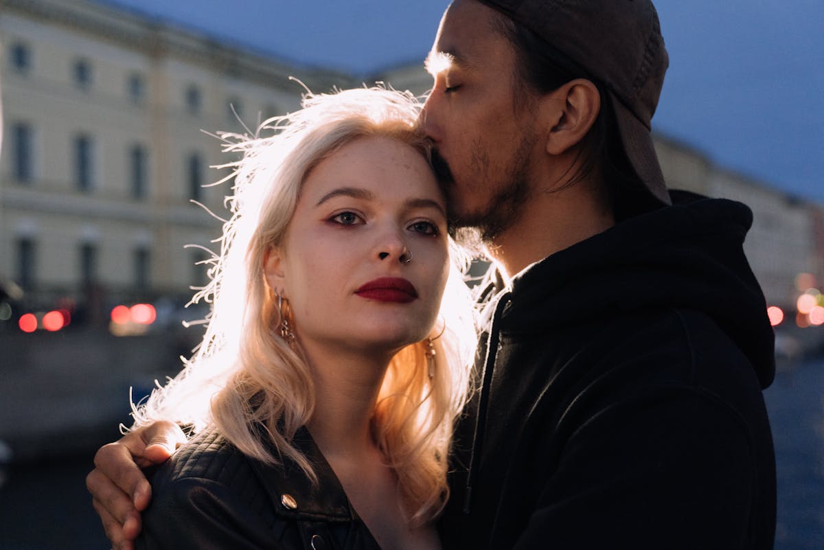 Man in Black Jacket Kissing Woman in White Shirt