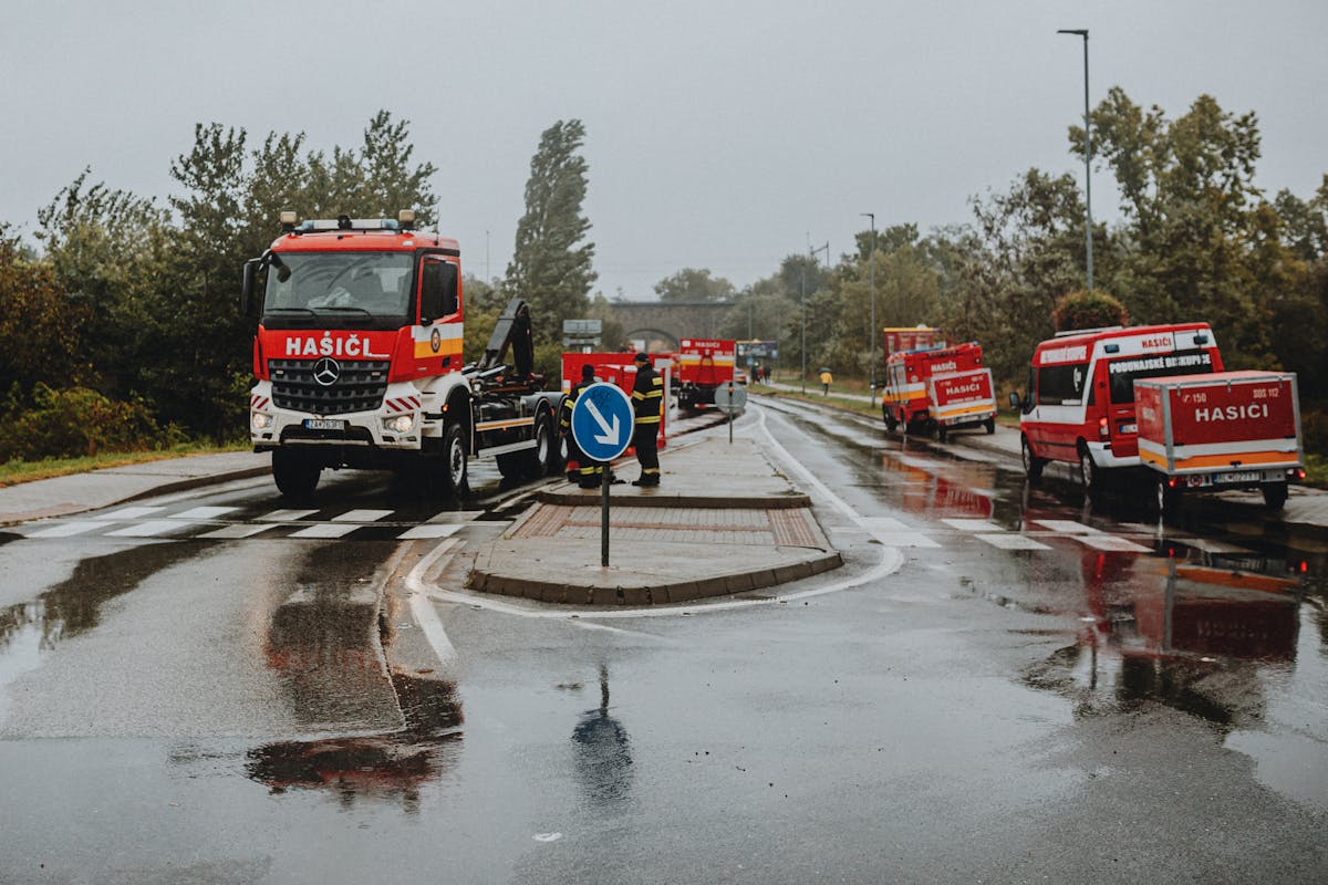 Firefighting Vehicles on Wet Road in Rainy Weather