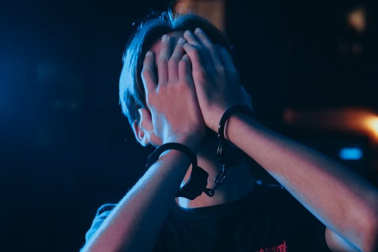 Man in Black Crew Neck T-shirt Covering His Face With His Hand
