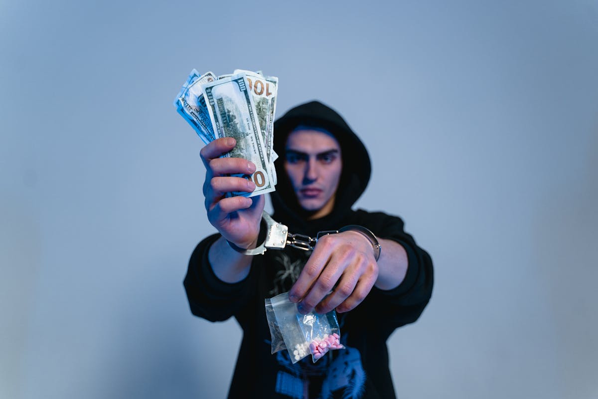 A Man in Black Hoodie Sweater Wearing Handcuffs