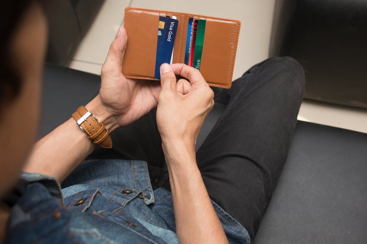 A Person Taking a Card from a Wallet