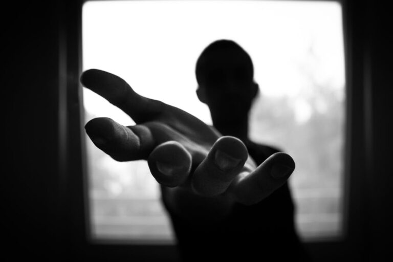 Man's Hand in Shallow Focus and Grayscale Photography