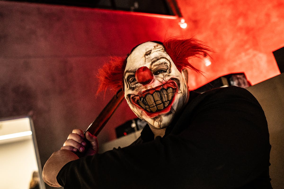 Person Holding An Ax With A Scary Mask